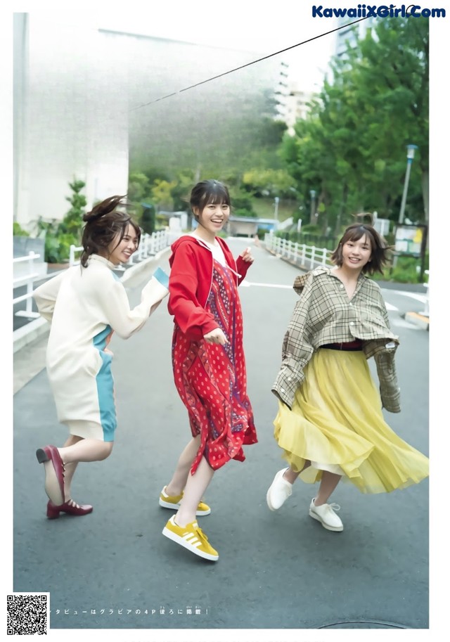 A group of young women walking down a street.