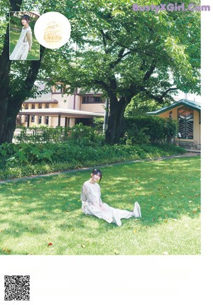 A woman in a black and white dress sitting on a bench.