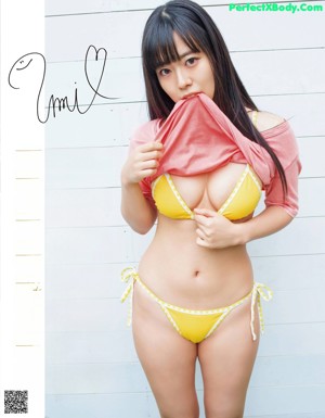 A woman in a white bra and panties posing for a magazine.