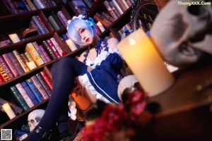 A woman dressed in a blue and white maid outfit.