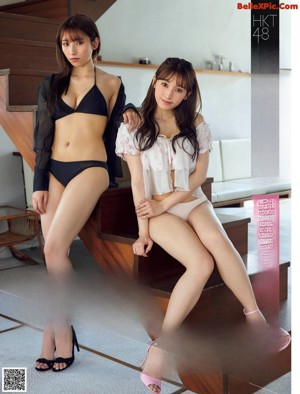 Two young women sitting next to each other on a couch.