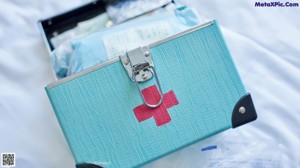 A woman in a white nurse outfit is opening a door.