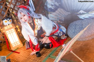 A woman in a kimono is sitting on the floor.